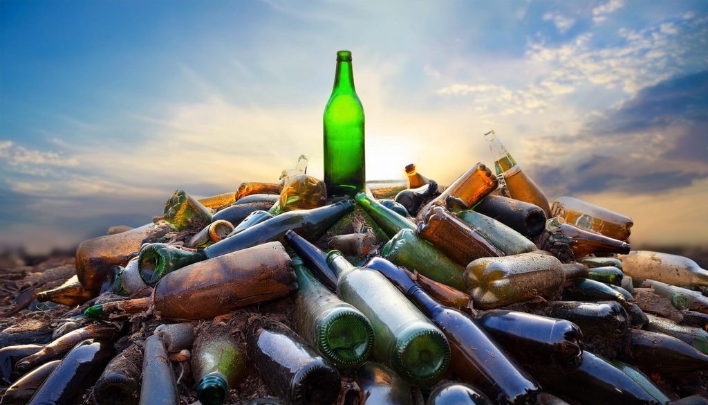 image of a pristine bottle on top of a pile of discarded, dirty bottles 77420